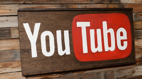 A wooden sign displaying the YouTube logo with a red background and white text.