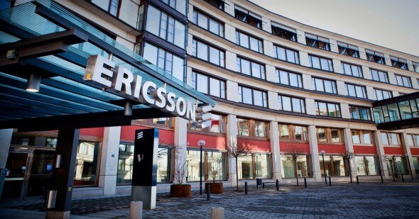 A view of the Ericsson building entrance,showcasing modern architecture with a large sign.