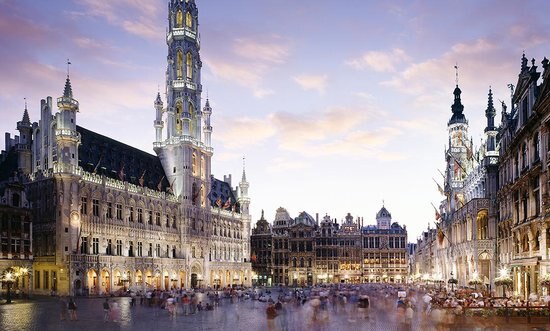 A beautiful sunset view of the Grand Place in Brussels,showcasing ornate architecture and lively atmosphere.