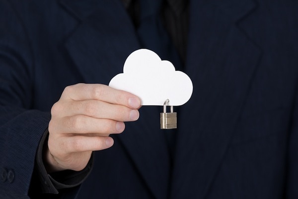 A person holding a paper cutout of a cloud with a padlock