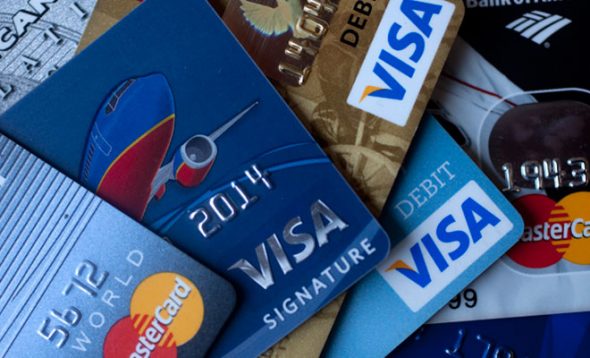 A collection of various credit and debit cards,including Visa and MasterCard,laid out together.