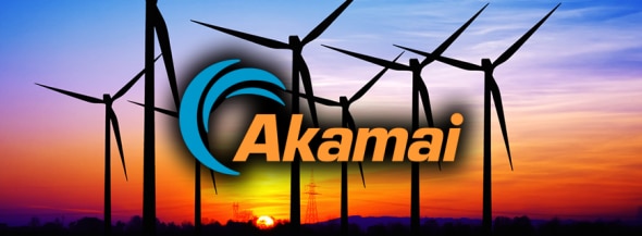 Silhouette of wind turbines against a colorful sunset with the Akamai logo prominently displayed.