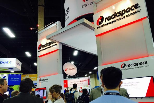 A view of the Rackspace booth at a trade event,showcasing its branding and promotional materials.