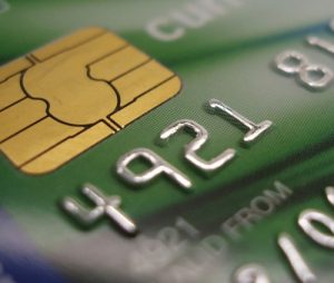 Close-up view of a credit card showing the chip and part of the card number.