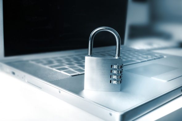 A combination lock placed on a laptop keyboard