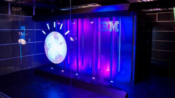 A digital display featuring the IBM logo and a circular visual element,illuminated with purple and blue lighting.