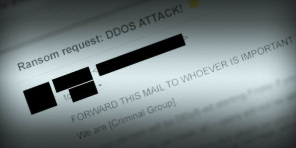 An email screenshot with a ransom request regarding a DDoS attack,containing blurred out sensitive information.