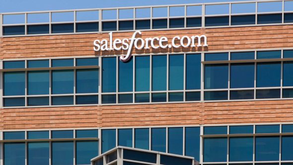 Exterior of a building featuring the Salesforce logo on a sunny day.