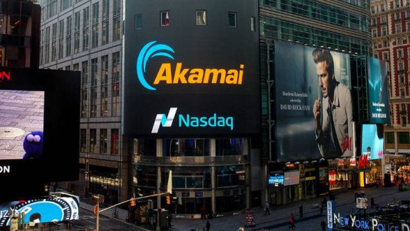 A digital billboard in Times Square featuring the Akamai logo and a Nasdaq advertisement.