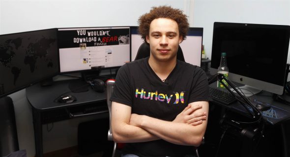 A person with curly hair sitting in a chair