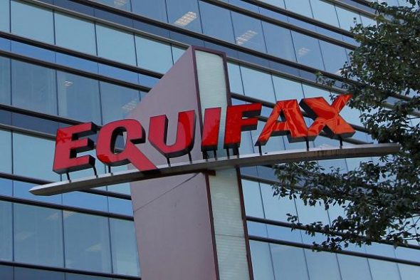 Sign of the Equifax building with modern architecture in the background.