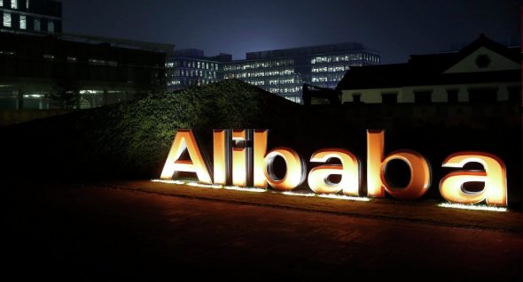 Illuminated sign of Alibaba at night.