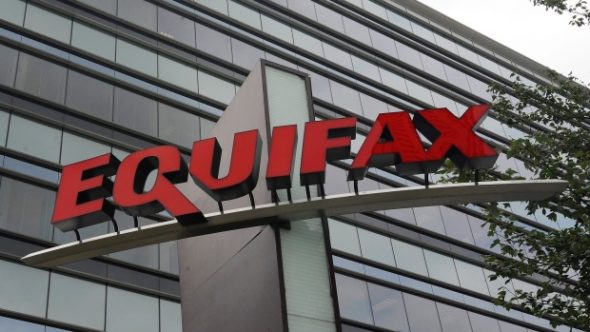 Sign of Equifax on a modern building facade.