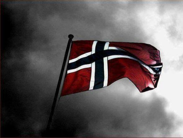 The flag of Norway waving in a dark,cloudy background.