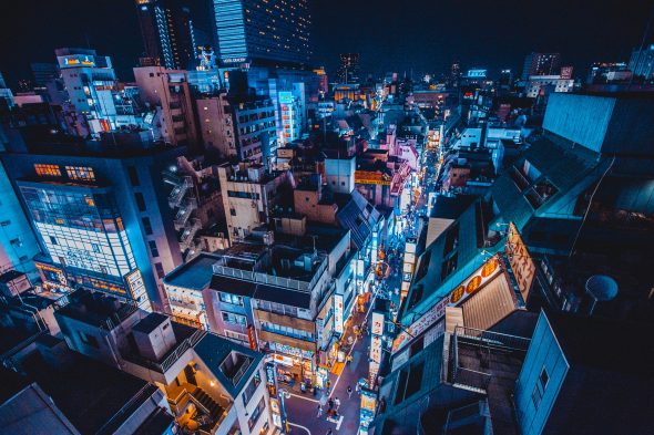 A vibrant cityscape at night,showcasing illuminated buildings and bustling streets.