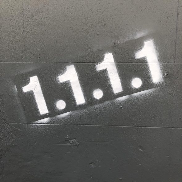 Graffiti depicting the numerical sequence '1.1.1.1' on a gray wall.