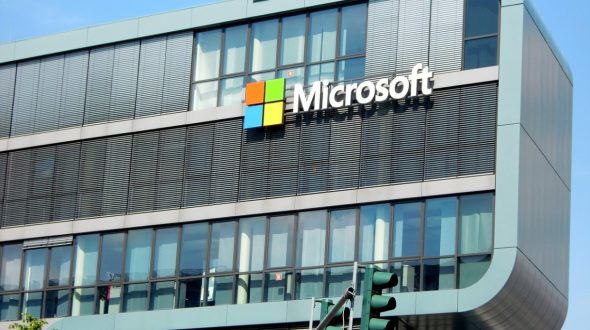 Exterior view of a Microsoft office building with the logo prominently displayed.