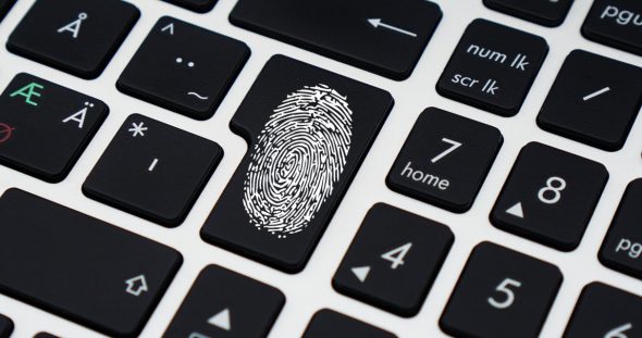 A black keyboard featuring a fingerprint design on one of the keys.