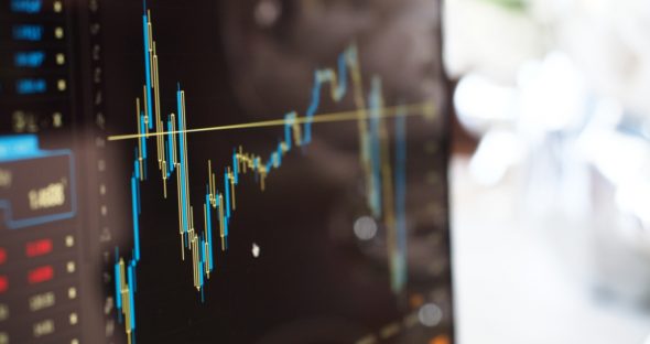 Close-up of a stock market graph displaying fluctuating data points on a digital screen.