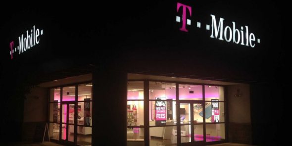 Exterior view of a T-Mobile store illuminated at night.