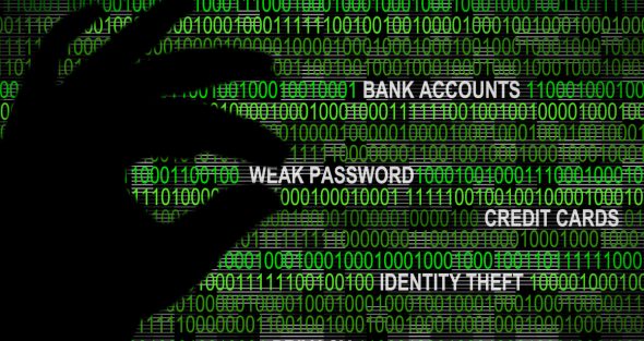 Silhouette of a hand over binary code with terms related to cyber threats.