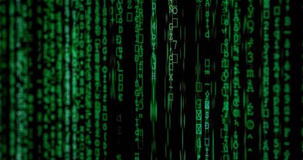 A digital representation of green falling characters resembling code from the Matrix.