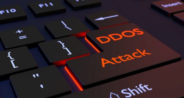 A close-up view of a computer keyboard highlighting the keys labeled 'DDOS' and 'Attack' in orange.