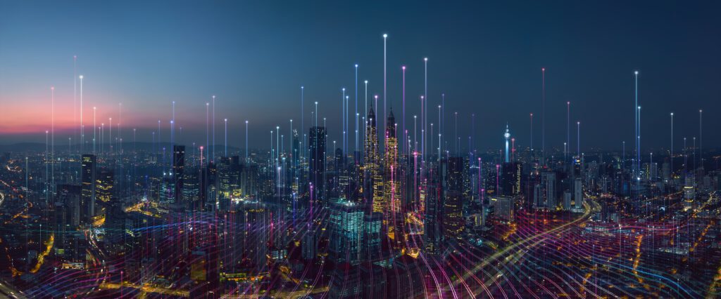 A panoramic view of a modern city skyline at dusk,featuring illuminated skyscrapers and vibrant light trails.