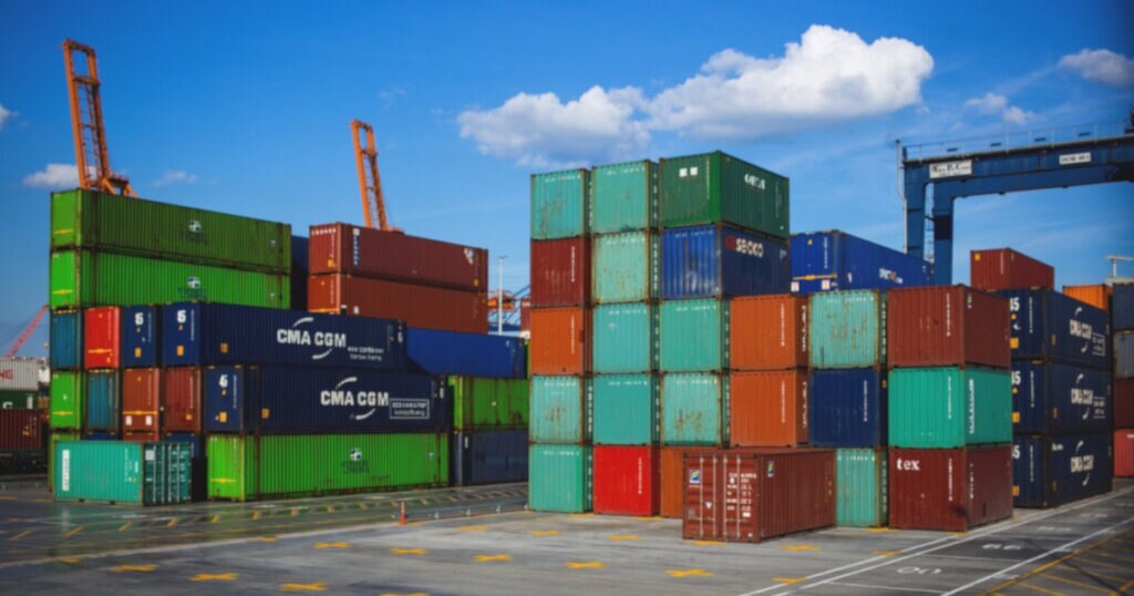 A stack of colorful shipping containers at a port