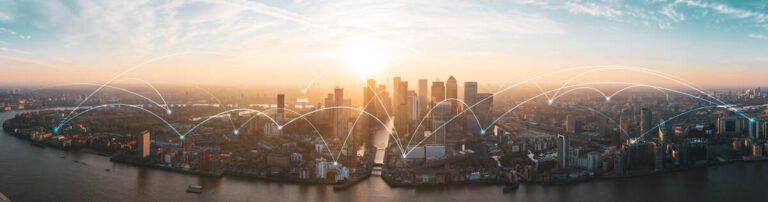 A panoramic view of a city skyline at sunset