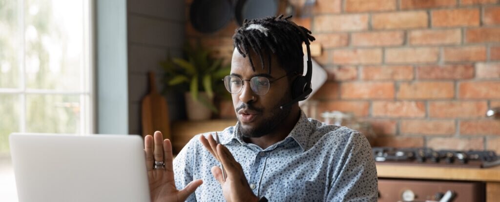 A man engaged in a virtual meeting