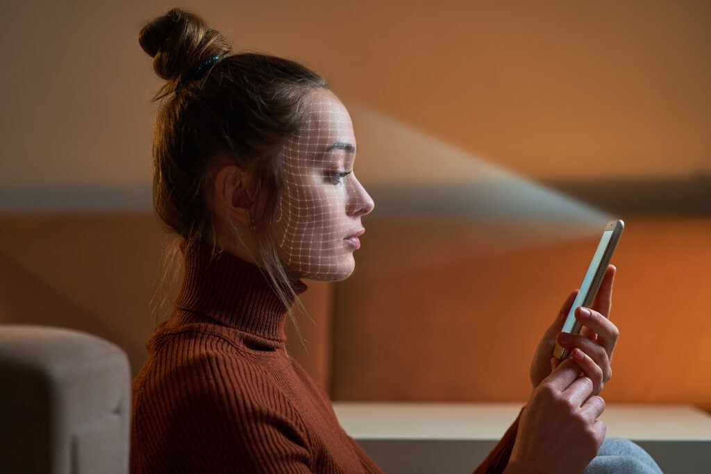 A side profile of a woman using a smartphone