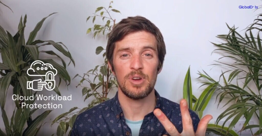 A person discussing cloud workload protection with a hand gesture,surrounded by indoor plants.