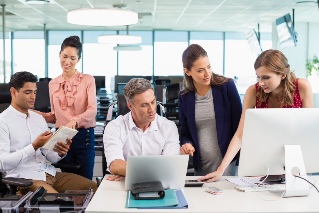 A group of five professionals collaborating in a modern office setting