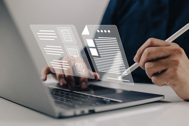 A person using a laptop while interacting with digital notes and documents displayed on a transparent interface.