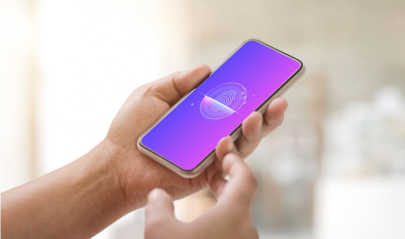 A hand holding a smartphone displaying a wireless signal graphic on a gradient purple background.