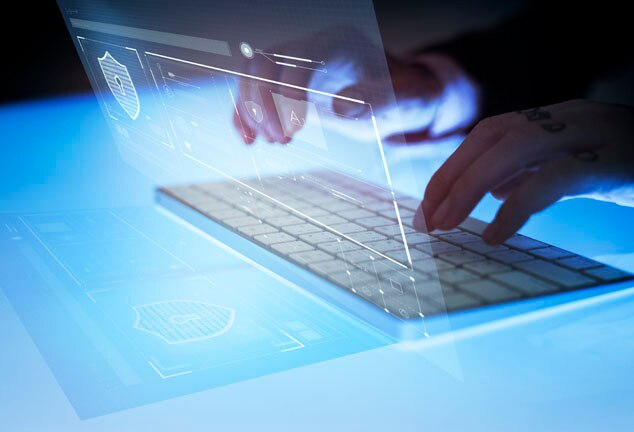 A person typing on a modern keyboard with a holographic display projected above it,showcasing data and security icons.