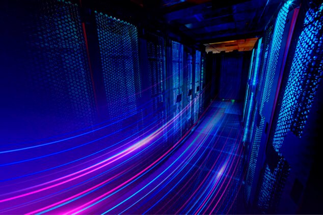 A futuristic server room with glowing blue and purple light trails.