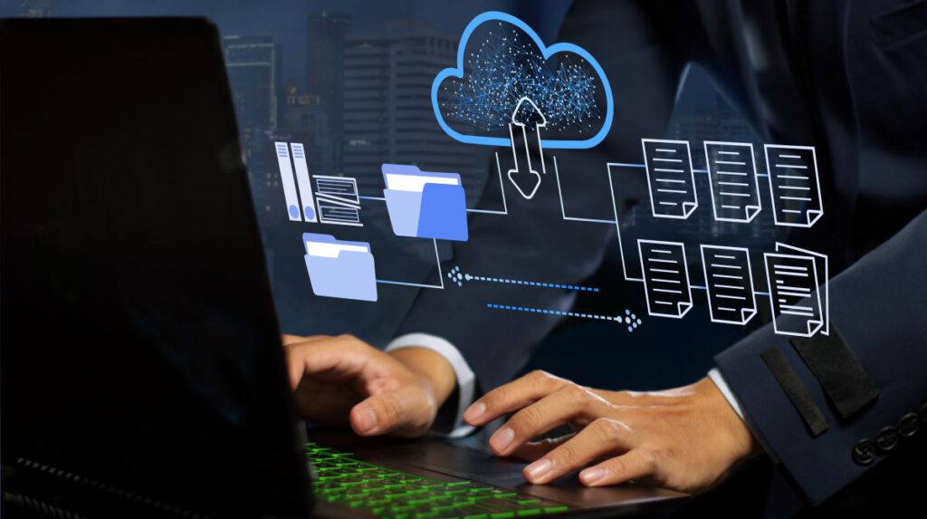 Hands typing on a laptop with cloud data storage graphics.