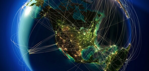 A visual representation of a global network,showing interconnected lines and illuminated areas over North and South America.