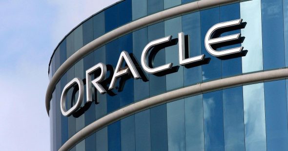 Oracle company logo displayed on a modern glass building.