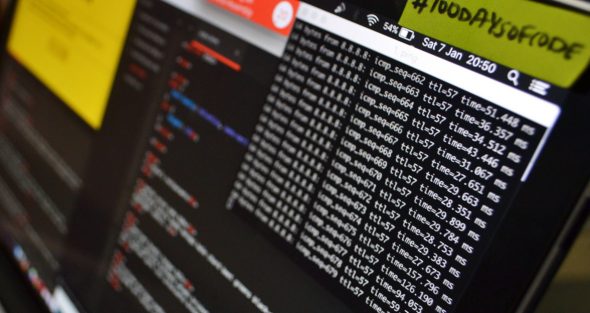 Close-up view of a computer terminal displaying lines of code and network metrics.