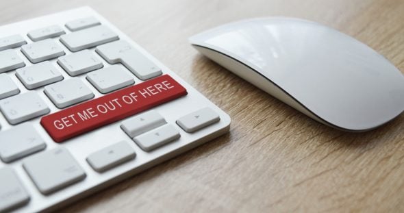 A keyboard with a red 'GET ME OUT OF HERE' button next to a mouse.